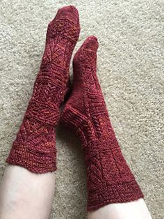 a person with their feet up on the floor wearing red knitted socks and leg warmers