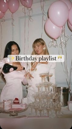 two women standing next to each other in front of pink balloons and champagne glasses on a table