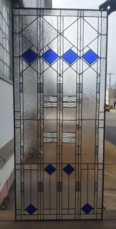 an old stained glass window sitting on the side of a building