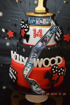 a three tiered cake decorated with hollywood stars