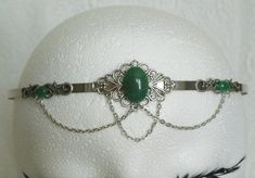 Green Agate Circlet This beautiful circlet has metal chain, sterling silver plated accents, sterling silver plated pendant and green agate settings. Adjustable. Handmade Silver Headband, Silver Metal Crown-shaped Jewelry, Silver Crown-shaped Metal Jewelry, Silver Crown Shaped Metal Jewelry, Adjustable Victorian Jewelry With Jewels, Victorian Adjustable Metal Jewelry, Adjustable Victorian Style Jewelry With Jewels, Victorian Style Adjustable Metal Jewelry, Adjustable Victorian Metal Jewelry