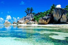 the water is crystal blue and clear with some rocks in it's foreground