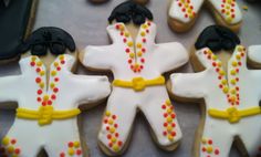 decorated cookies in the shape of elvis and ladybug suits are arranged on a table