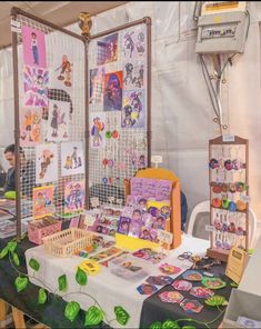 a table covered with lots of cards and magnets on it's sides in front of a white wall