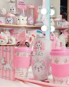 pink and white items are on display in front of a mirror with hello kitty decorations