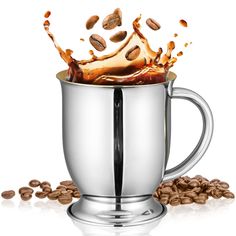 a cup filled with coffee beans and splashing liquid