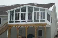 a large house with a deck and stairs leading up to it