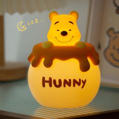 a winnie the pooh night light sitting on top of a table