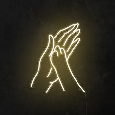 two hands reaching for each other in the air with neon lights above them on a black background