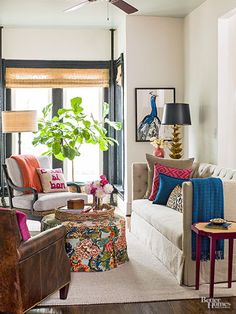 a living room filled with furniture and a ceiling fan in the middle of the room