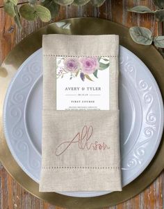 the place setting is set on top of a plate with silverware and napkins