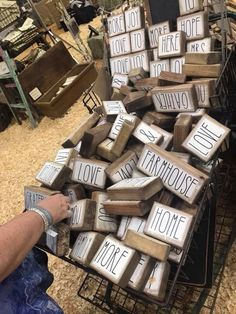 a man is holding up some type of wooden blocks with words on them in the shape of letters that spell out love