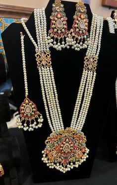 Experience the stunning beauty of our Noratan Mala, Earrings and Teeka Set. This extraordinarily gorgeous jewelry set seamlessly combines Indian and Pakistani design with precious gemstones, creating a timeless elegance. Handcrafted with intricate details, it symbolizes beauty and spirituality. Adorn your look with grace and sophistication, making a statement for any occasion. Explore our shop and immerse yourself in the enchanting allure of the Noratan Mala Set. Traditional Bridal Accessories With Stone Work For Wedding, Traditional Wedding Bridal Accessories With Stone Work, Traditional Bridal Earrings With Intricate Design For Puja, Traditional Kundan Bridal Accessories, Traditional Kundan Bridal Accessories For Wedding, Traditional Chandbali Bridal Accessories For Wedding, Bollywood Style Intricate Design Sets For Puja, Festive White Kundan Wedding Jewelry, Traditional Bridal Accessories For Diwali Wedding