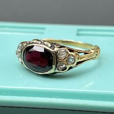 This listing is for garnet ring only ~ Video sows different rings available in our shop which are sold separately . Fabulous antique ~ late Victorian / Art Nouveau~ 14kt solid yellow gold ~ open back faceted deeply colored garnet with three small Old Mine Cut diamonds on each side ~ The sides have leafy design with ornate ring shank . Unmarked but acid tested by professional jeweler for 14kt solid gold . Date: late 19th to early 20th century . Materials: 14K yellow and faceted garnet ( approx si Antique Yellow Gold Rings With Rose Cut Diamonds, Antique Gold Ruby Ring Stamped 14k, Victorian Ruby Ring In Stamped 14k Yellow Gold, Antique 14k Yellow Gold Ruby Ring, Antique Red Diamond Ring With Rose Cut Diamonds, Antique Ruby Diamond Ring Hallmarked, Victorian Yellow Gold Diamond Ring With Gemstone, Victorian Gold Diamond Ring With Ruby, Antique 14k Stamped Yellow Gold Ruby Ring