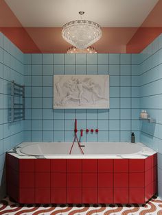 a bathroom with red and blue tiles on the walls, an oval chandelier hanging over the bathtub