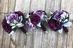 three bridesmaids bouquets with purple flowers and greenery on wooden planks