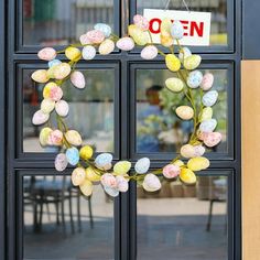 an easter wreath is hanging on the front door