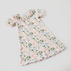 Our 'Pink Magnolia' girls organic cotton dress is the perfect dress for your sweet Southern little girl!All Nola Tawk play dresses are made with:- GOTS certified 100% organic cotton- Accent buttons on front bodice- Pleated front bodice- Elastic puff sleeve Spring Twirl Dress For Playwear, Spring Short Sleeve Twirl Dress For Playwear, Playful Cotton Loungewear Dress, Spring Cotton Bedtime Dress, Cotton Twirl Dress With Short Sleeves For Playwear, Fitted Cotton Twirl Dress With Short Sleeves, Fitted Cotton Twirl Dress For Playwear, Cotton Short Sleeve Dress For Sleepover, Short Sleeve Twirl Dress With Ruffles For Playwear