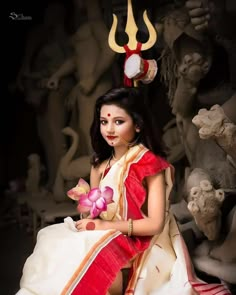 a woman in a white and red dress holding a flower