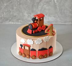 a birthday cake that is shaped like a train engine and number four on top of it