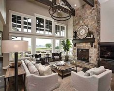 a living room filled with furniture and a large clock mounted to the wall above it