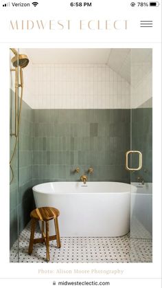 a white bath tub sitting next to a wooden stool