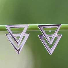 Super-imposed triangles set a geometrical spell of elegance in earrings by Lalana. The Thai artisan works in sterling silver giving the earrings a limpid high polished finish. Formal Geometric Sterling Silver Jewelry, Elegant Triangle Sterling Silver Earrings, Formal Sterling Silver Geometric Jewelry, Sterling Silver Triangle Earrings For Pierced Ears, Sterling Silver Geometric Jewelry For Formal Occasions, Silver Triangle Minimalist Earrings, Formal Triangle Sterling Silver Jewelry, Nickel-free Triangle Sterling Silver Jewelry, Minimalist Silver Pyramid Jewelry