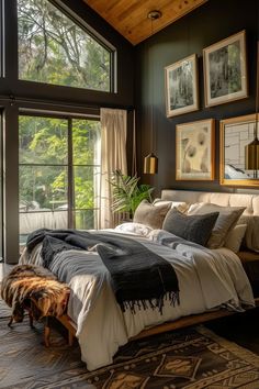 a large bed sitting in a bedroom next to a window with pictures on the wall