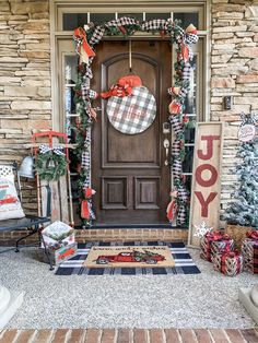 a front door decorated for christmas with holiday decorations