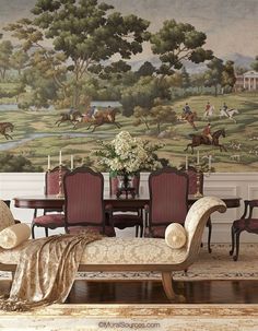 a living room filled with furniture and a painting on the wall