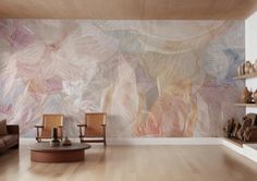 a living room with two chairs and a wall mural