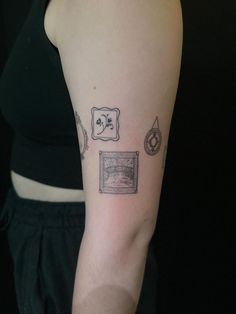 a woman with a tattoo on her arm that has pictures and symbols all over it