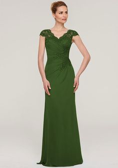 a woman in a long green dress with lace detailing on the shoulders and shoulderline