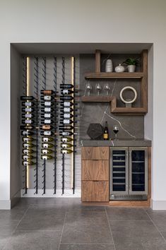 a wine rack with bottles and glasses on it in a room that has tile flooring