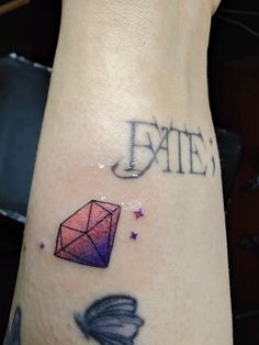 a close up of a person's arm with tattoos on it and an image of a diamond