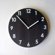 a black clock with white numbers on it