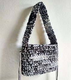 a black and white purse hanging on the wall