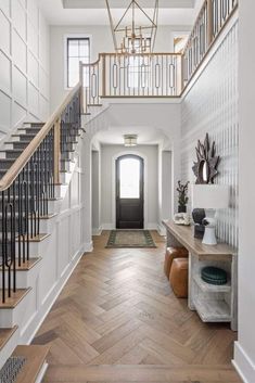 a foyer with wooden floors and white walls