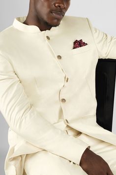 Step into elegance and style with our Merino Cream Bandhgala Premium Cotton Stretchable Blazer. This sophisticated ensemble combines traditional Indian aesthetics with contemporary fashion. Crafted from premium cotton, it offers a comfortable and breathable fit. The bandhgala, with its intricately designed mandarin collar and metallic button detailing, adds a touch of regal charm. Make a statement at any occasion with this truly unique and fashionable piece. In addition to being constructed from Designer Cotton Kurta For Formal Occasions, Classic Bandhgala With Stand Collar For Festive Occasions, Formal Cotton Bandhgala For Festive Occasions, Cotton Bandhgala For Formal Festive Occasions, Designer Cotton Bandhgala For Festive Season, Designer Cotton Bandhgala For Festive Occasions, Elegant Cotton Wedding Suit, Elegant Wedding Cotton Suits, Elegant Fitted Sets With Stand Collar