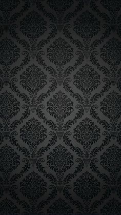 black wallpaper with an ornate design on it