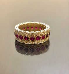 DeKara Designs Collection Metal- 18K Yellow Gold, .750. Stones- 20 Genuine Round Rubies 2.40 Carats, 120 Round Diamonds F-G Color VS1 Clarity 0.55 Carats. Entirely Handmade 18K Yellow Gold Eternity Diamond Round Ruby Engagement Band. This band is extremely elegant featuring beautiful and fiery rubies that are all professionally burnish set individually with amazing bead work surrounding each stone. There are 60 professionally pave set round diamonds on the top and bottom of band, which gives the 6th Wedding Anniversary, Engagement Band, Gold Art Deco, Engagement Bands, Art Deco Diamond, Diamond Wedding Band, Vintage Band, Ruby Diamond, Gold Art