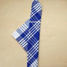 a blue and white checkered tie on a tan background