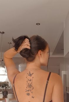 a woman with a tattoo on her back