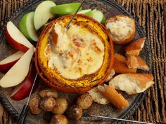 a plate with bread, apples and other food on it