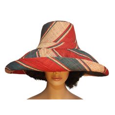 This beautiful, lightweight raffia hat features a 7-inch brim that we weave by hand in Madagascar. Its shape-able brim allows the owner to wear the hat in many different styles. This adjustable hat is an eco-friendly product crafted from natural Raffia and other renewable and sustainable raw materials utilizing various energy-saving techniques. It contains a comfortable cotton lining with an adjustable drawstring in its interior. All the colors on this hat were achieved using a long-lasting dye made from vegetables. Its dual layer of fine woven Raffia offers UPF 50+/SPF 30+ sun protection, making it an excellent hat for extended outdoor use. Our big-brim Madagascar raffia hats are packable and can be folded or rolled easily for traveling. It is perfect for use as a sun hat, cruise hat, chu Handwoven Toquilla Straw Hat With Curved Brim, Handwoven Brimmed Toquilla Straw Hat, Handwoven Curved Brim Panama Hat, Handwoven Toquilla Straw Brimmed Hat, Handwoven Toquilla Straw Sun Hat With Curved Brim, Handwoven Straw Panama Hat With Curved Brim, Sinamay Straw Hat With Curved Brim, Short Brim Woven Toquilla Straw Hat, Woven Toquilla Straw Hat With Short Brim