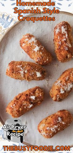 some food is on a white plate with the words homemade spanish style croquettes