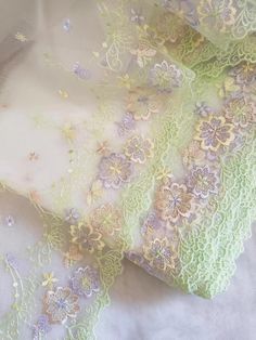 the fabric is covered with lace and flowers