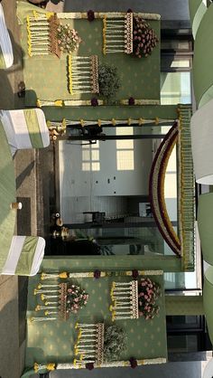 an overhead view of a dining room with green and yellow decor on the tables, chairs and rugs