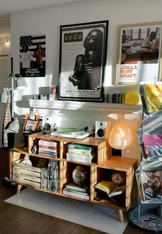 a living room filled with lots of furniture and pictures on the wall above it's bookshelf