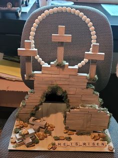 a cake made to look like a castle with a cross on top and other items around it